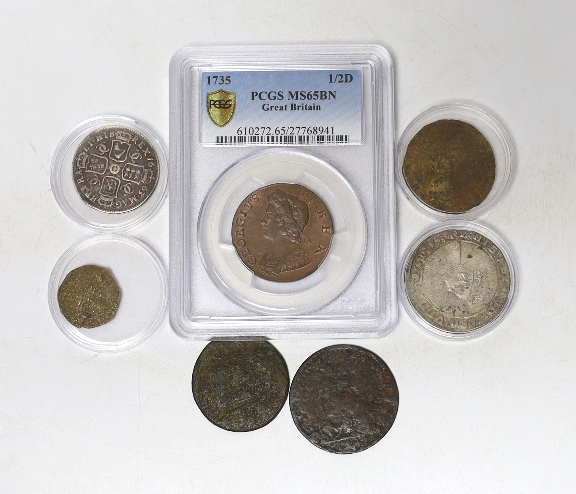 Seven coins including; a Charles II 1663 shilling, an Edward VI silver shilling, a George II 1735 half penny (PCGS graded MS65BN) together with four other coins